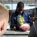 Michigan defensive back Blake Countess signs a football for a fan during beach day in Clearwater, Fla. on Sunday, Dec. 30. Melanie Maxwell I AnnArbor.com
